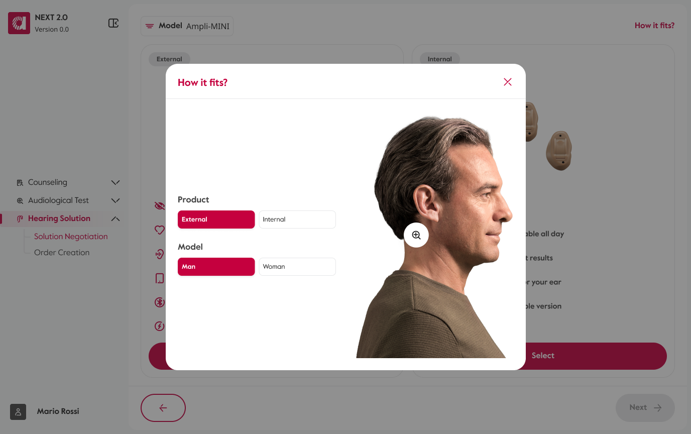The “How it fits?” overlay open above the comparison: External/Internal product and Man/Woman model selectors on the left, and on the right the model in profile wearing the selected aid — an external one, so it sits behind the ear and is barely visible — with a zoom control over it.